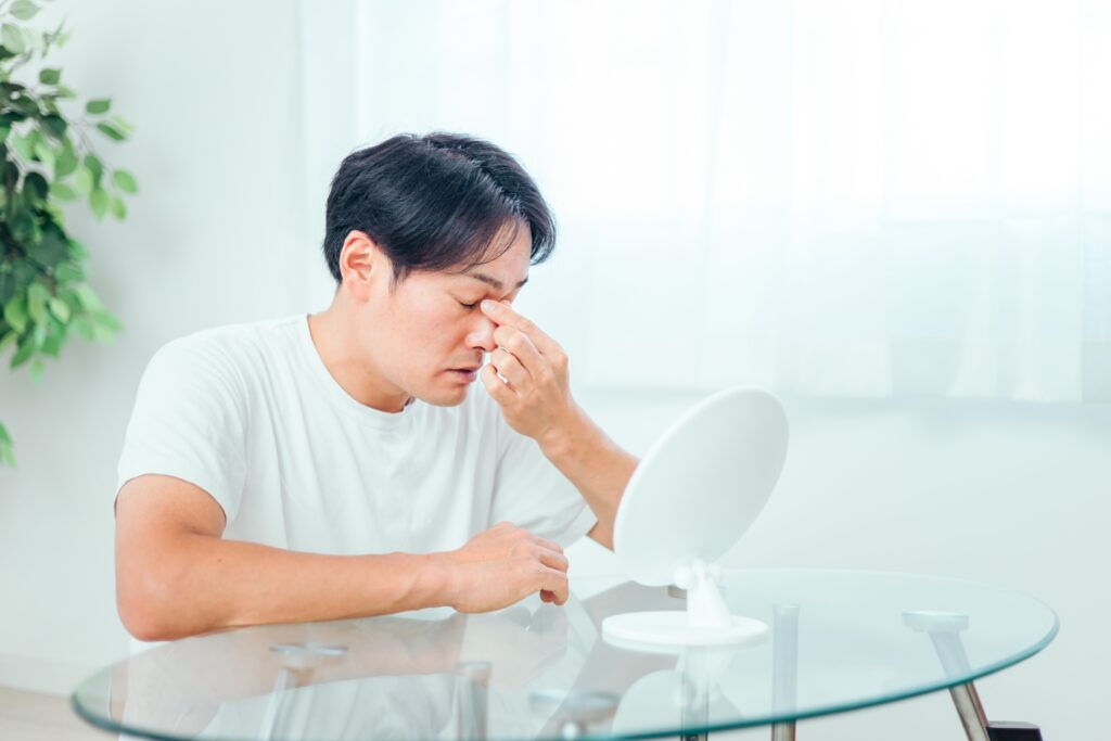 目元を気にする男性